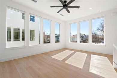 Unfurnished sunroom with ceiling fan and visible vents