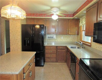 Updated kitchen features Quartz counter tops, upgraded appliances, center island and ceramic tile flooring.