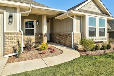 Doorway to property featuring brick siding and a s