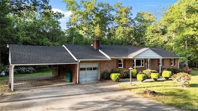 Ranch-style house with brick siding, a carport, an