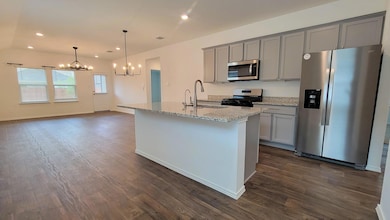 Kitchen with stainless steel appliances, a chande