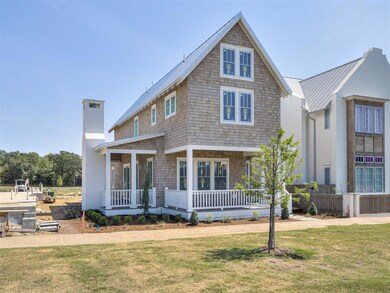 View of front of house with covered porch and a fr