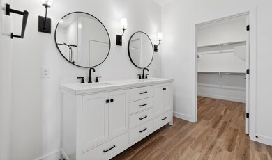 Primary bath features freestanding vanity with dual sinks