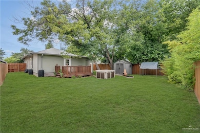 View of yard featuring a storage shed and a deck
