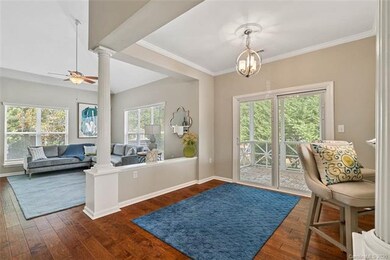 Dining area with decorative columns and access to screened porch!