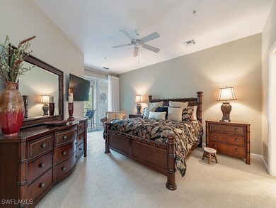 Carpeted bedroom featuring ceiling fan