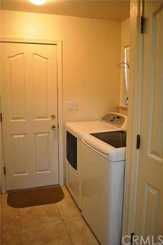 The indoor laundry area is nicely sized and has a 