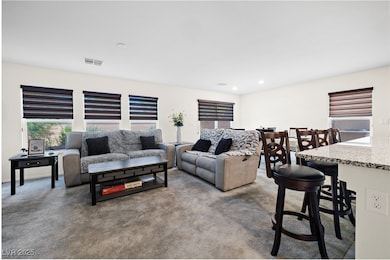 Carpeted living area with recessed lighting