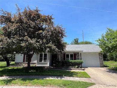 View of front of house featuring a garage, concrete driveway, a shingled roof, and brick siding