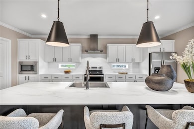 Kitchen with a kitchen breakfast bar, white cabinets, light stone counters, ornamental molding, and recessed lighting