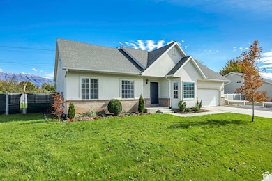 Ranch-style home with stucco siding, brick siding, a shingled roof, and concrete driveway