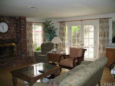 The family room with a brick fireplace and a wet b