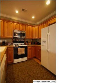 Appliances with oak cabinetry.