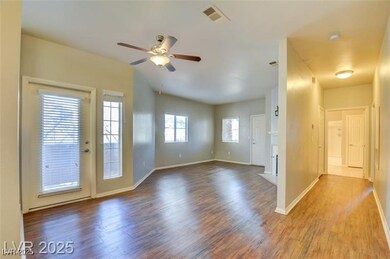 Spare room featuring wood finished floors and a ce