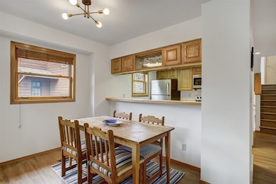 Dining area featuring baseboards, wood finished fl