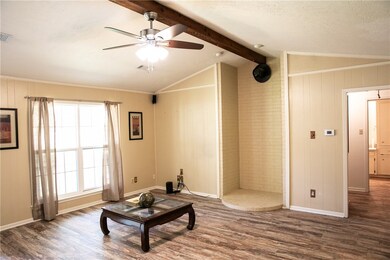 Living area with visible vents, crown molding, woo