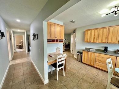Front Entrance with view of Kitchen to the Right and Den/Bedroom to the Left