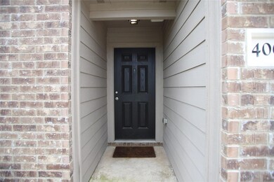 Entrance to property featuring brick siding