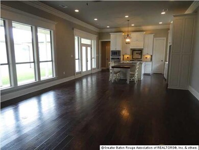 The living room with a wall of windows overlooks t