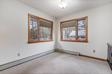 Empty room featuring baseboards, carpet flooring, 