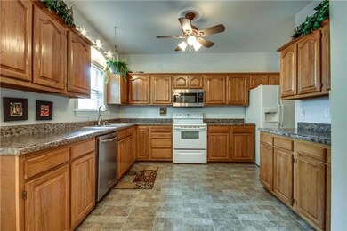 Bright kitchen with ceiling fan and updated counter tops