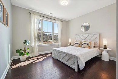 Bedroom featuring dark wood-style flooring