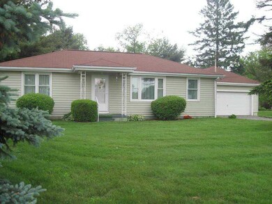 Exterior Front. Spacious front yard and mature shr