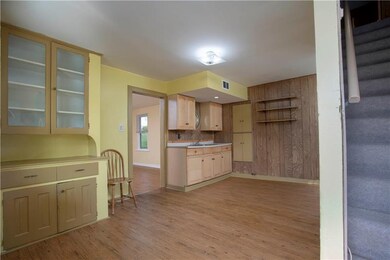 EAT-IN KITCHEN features oak cabinetry, laminate fl