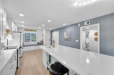 Kitchen with range with electric stovetop, light s