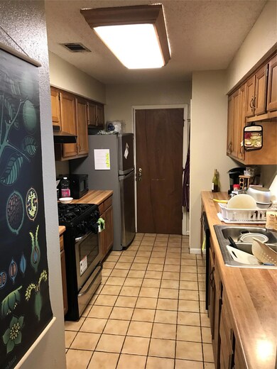Kitchen with range, butcher block counters, extra