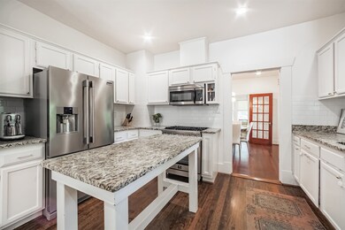 Spacious kitchen features granite countertops, isl