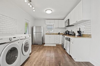Kitchen featuring independent washer and dryer, wh