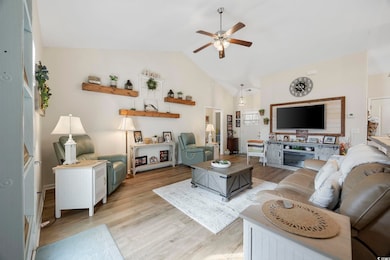 Living room with a ceiling fan, light wood-type fl