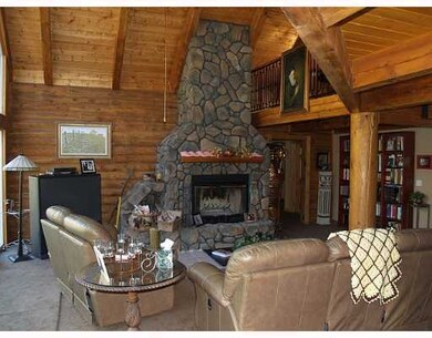Living Room. Floor to ceiling stone fireplace sets
