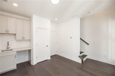 The wet bar in the media room with soft painted cabinetry has ample space for mixing drinks or serving snacks without missing a moment of the action.