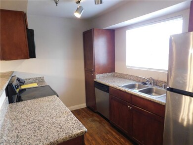 Kitchen featuring dark wood-style flooring, applia
