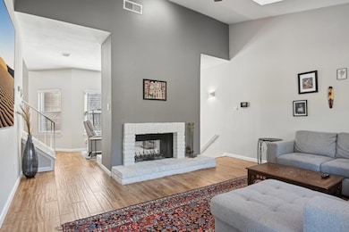 Living area featuring a brick fireplace, wood fini