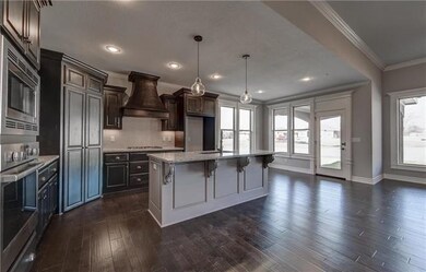 Designer chef’s kitchen includes black silgranite 