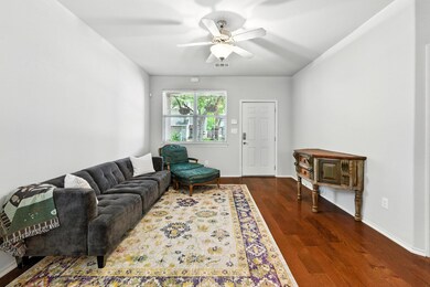 Living area featuring wood finished floors and ce