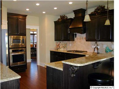This is the kitchen in the Model, this home will have the SAME features, Gas cooktop,GE Profile Appliances, 5' hardwood floors in foyer, dining, kitchen & breakfast areas