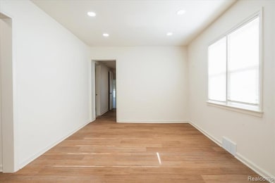 Empty room with recessed lighting and light wood finished floors