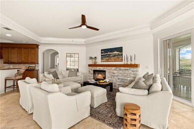 Living area featuring crown molding, arched walkwa