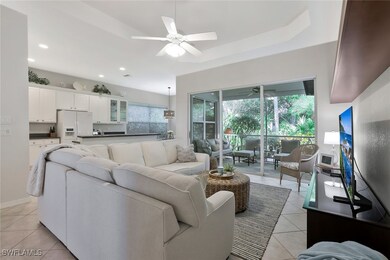 Living room with Tray Ceiling and a wealth of natu