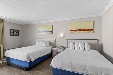 Bedroom featuring wood finished floors and a textured ceiling