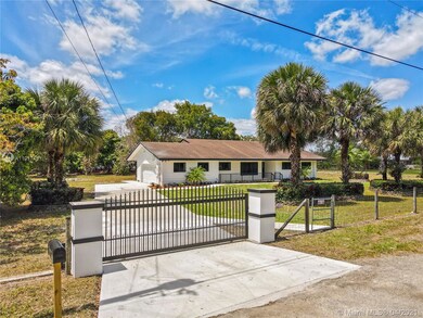 FRONT VIEW OF PROPERTY WITH SOLAR GATES, NEW DRIVE