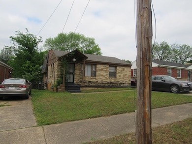 Bungalow-style house featuring a front lawn, a shingled roof, and brick siding