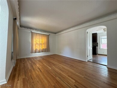 Great room with hardwood / wood-style floors, ceiling fan, and a textured ceiling