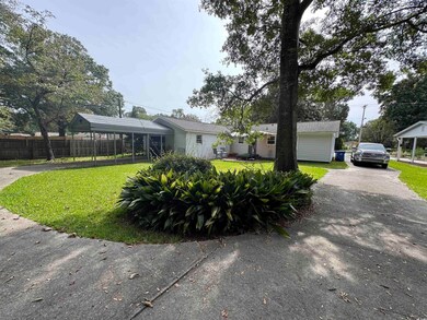 Single story home featuring a carport and a front 