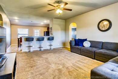Kitchen opens into living space with bar seating&#