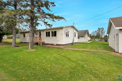 Rear view of house with a yard and crawl space